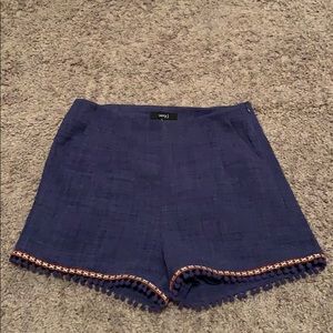 Navy blue high waisted shorts with Pom poms.